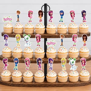 May include: A three-tiered wooden cupcake stand holding twenty-four cupcakes topped with colorful Strawberry Shortcake character paper toppers. Each cupcake features a unique character cutout or a Strawberry Shortcake logo sign.