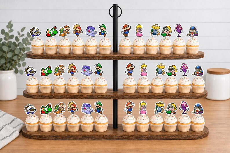 May include: A three-tiered wooden cupcake stand holding numerous cupcakes topped with colorful paper cutouts of various Super Mario characters, including Mario, Luigi, Princess Peach, Yoshi, and other iconic figures from the video game series.