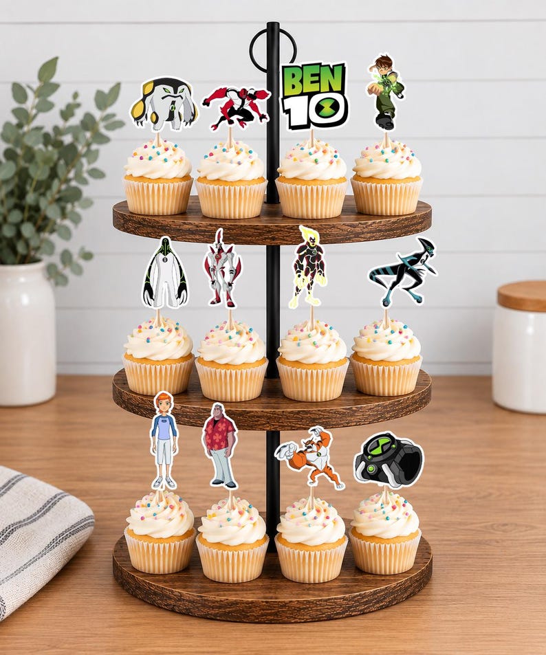 May include: A three-tiered wooden cupcake stand holding twelve cupcakes topped with white frosting and colourful sprinkles. Each cupcake features a Ben 10 themed paper topper, including various character illustrations and the Ben 10 logo text.