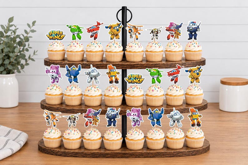 K&ouml;nnte beinhalten: Ein dreist&ouml;ckiger Cupcake-St&auml;nder aus Holz mit vierundzwanzig Cupcakes, die jeweils mit einem Super Wings-Charakter oder Logo-Aufstecker versehen sind. Die Cupcakes haben eine wei&szlig;e Glasur mit bunten Streuseln und stehen auf den dunklen Holzablagen.