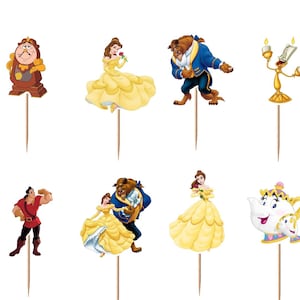 May include: A set of twelve decorative cupcake toppers featuring various characters and objects from Beauty and the Beast, including a red rose in a glass dome, a clock, a candelabra, a teapot, and figures of Belle, the Beast, and Gaston.