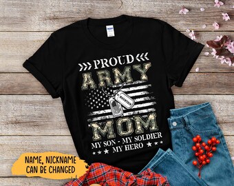 May include: Black t-shirt with the text "PROUD ARMY MOM" in white and camouflage lettering. The design includes an American flag and dog tags. The text "MY SON - MY SOLDIER - MY HERO" is also printed on the shirt.