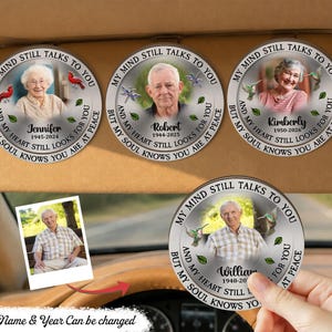 May include: Circular memorial car coasters with photos of individuals, surrounded by text that reads "My Mind Still Talks To You, But My Heart Still Looks For You, And My Soul Knows You Are At Peace." The names and dates are also included.