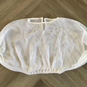 May include: White mesh top with a gathered neckline and elastic at the bottom.