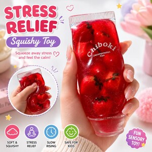 May include: A clear, tube-shaped squishy toy filled with red gel and small red objects, possibly strawberries. The text "STRESS RELIEF Squishy Toy" is displayed at the top. The toy is labeled "Chiboki Decompression toys".