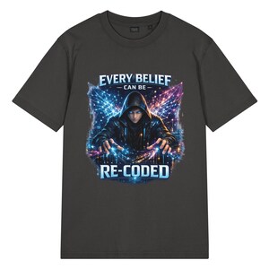 May include: A charcoal gray t-shirt featuring a graphic print of a hooded figure with glowing blue eyes and hands, surrounded by digital light patterns. The text above reads EVERY BELIEF CAN BE and the text below reads RE-CODED in blue lettering.