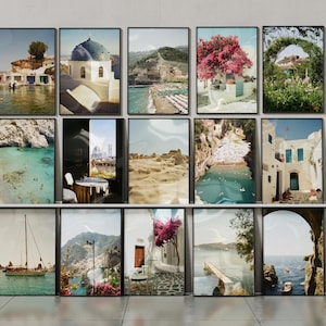 May include: A collection of framed landscape art prints featuring coastal scenes, architecture, and nature. The prints showcase various locations with vibrant colors, including beaches, buildings, and floral elements. Each print is in a black frame.