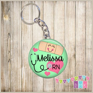 May include: A green round keychain with a white bandage with a smiley face, a stethoscope, a pink heart with the letters RN, and the name Melissa.