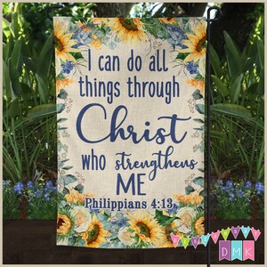 May include: A garden flag with a burlap background featuring sunflowers and blue flowers. The text reads "I can do all things through Christ who strengthens ME Philippians 4:13".