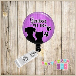 May include: A purple and white striped badge reel with a black silhouette of a dog and cat. The text "Jensen VET TECH" is printed on the badge reel.