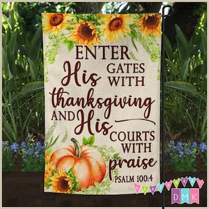 May include: A fall-themed garden flag with a pumpkin and sunflowers. The flag has the text "Enter His Gates with Thanksgiving and His Courts with Praise Psalm 100:4".