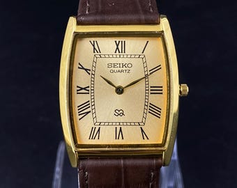 The classic Seiko Slim Vintage Barrel Quartz Men's Wrist Watch With Golden Dial and New Brown Croco Leather Strap