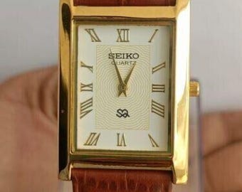 The classic Seiko Slim Vintage Rectangular Quartz Men's Wrist Watch With White Dial and New Tan Band