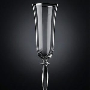 May include: A tall, clear champagne flute with a slender stem and a wide, flared bowl. The glass is made of clear glass and has a delicate, elegant design. The flute is perfect for serving sparkling wine or champagne.