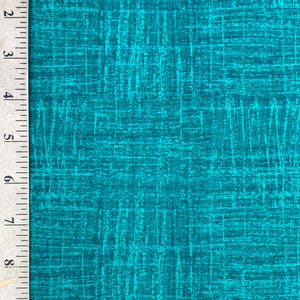 May include: Teal fabric with a textured, crosshatch pattern. The fabric has a ruler along the left side, marked in inches. The fabric's design features a network of intersecting lines, creating a visual texture.