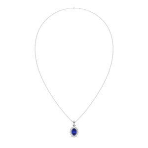 May include: A silver necklace featuring a pendant with a large, oval-shaped, deep blue gemstone surrounded by smaller, clear gemstones. The pendant hangs from a delicate silver chain, creating an elegant and classic look.