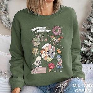 May include: Military green sweatshirt featuring cartoon characters and the text "You can be whatever you wish to be" and "The Big Donut". The design includes a police badge, a sloth, a fox, a bunny, and other characters.