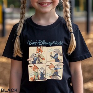 May include: Black t-shirt featuring a colorful graphic of characters from Zootopia. The design includes images of Nick Wilde and Judy Hopps with the text "Walt Disney World". The word "BLACK" is printed at the bottom.