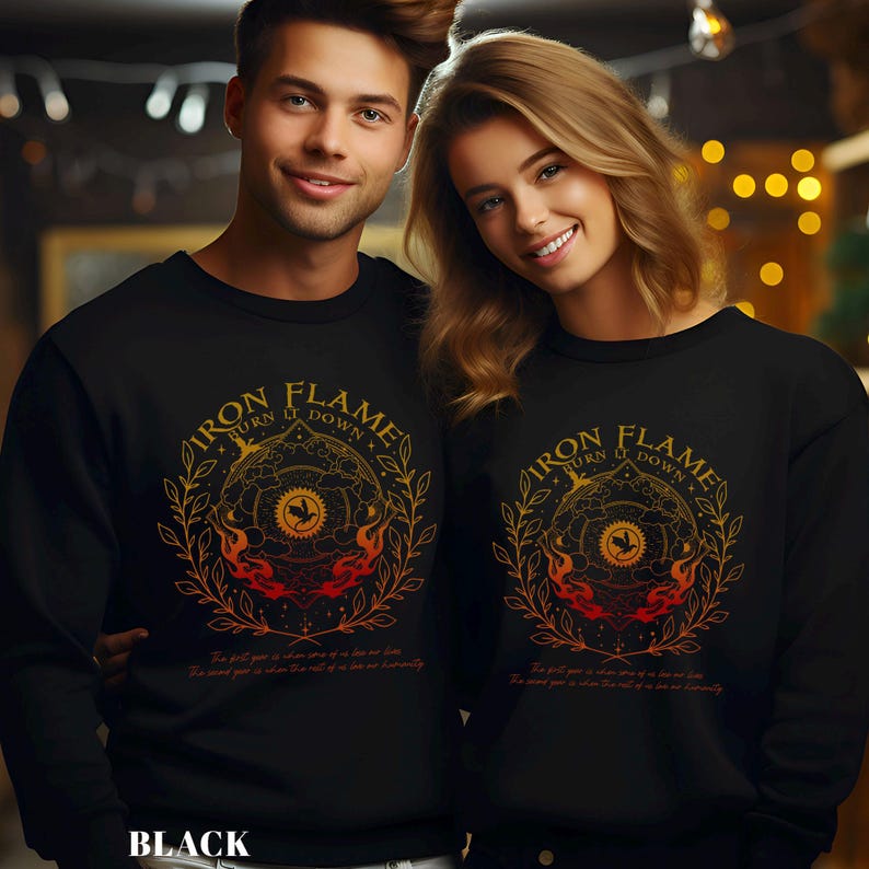 May include: Black sweatshirts with a circular graphic featuring the text "IRON FLAME TURN IT DOWN" in gold lettering. The design includes a central emblem, flames, and botanical elements. The text "The full year is when one of us live our lives. The mind year is when the rest of us live eternally" is below the graphic.