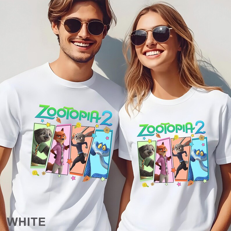 May include: White t-shirts with the text "ZOOTOPIA 2" in green and blue, and character illustrations in colourful rectangular frames. The shirts are worn by two people, and the word "WHITE" is printed at the bottom.