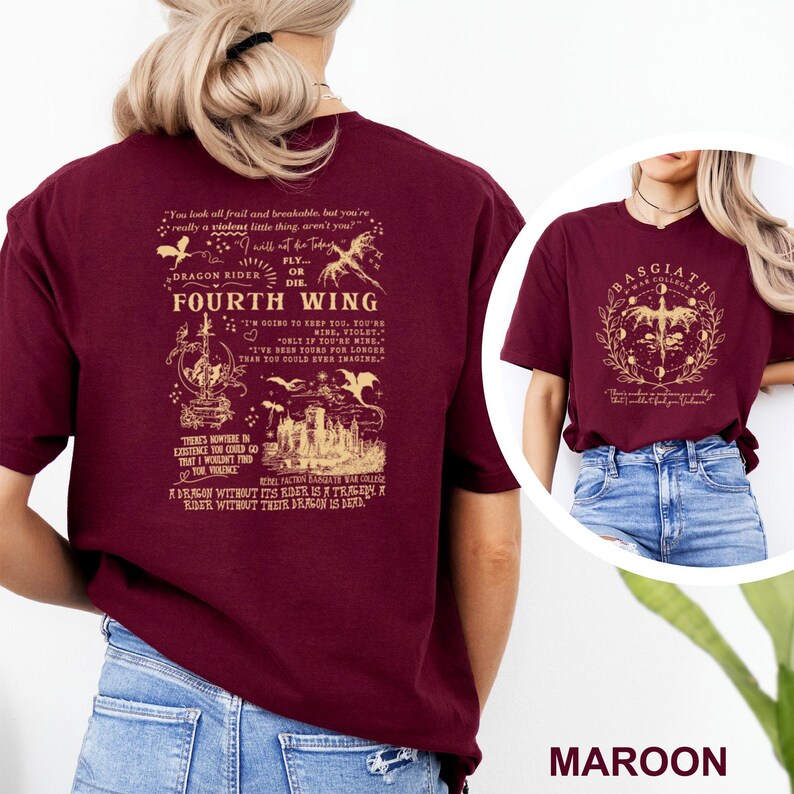 May include: Maroon t-shirt featuring the text "FOURTH WING" with a dragon and castle graphic. The back of the shirt has additional text and illustrations. The shirt is made of a soft material.