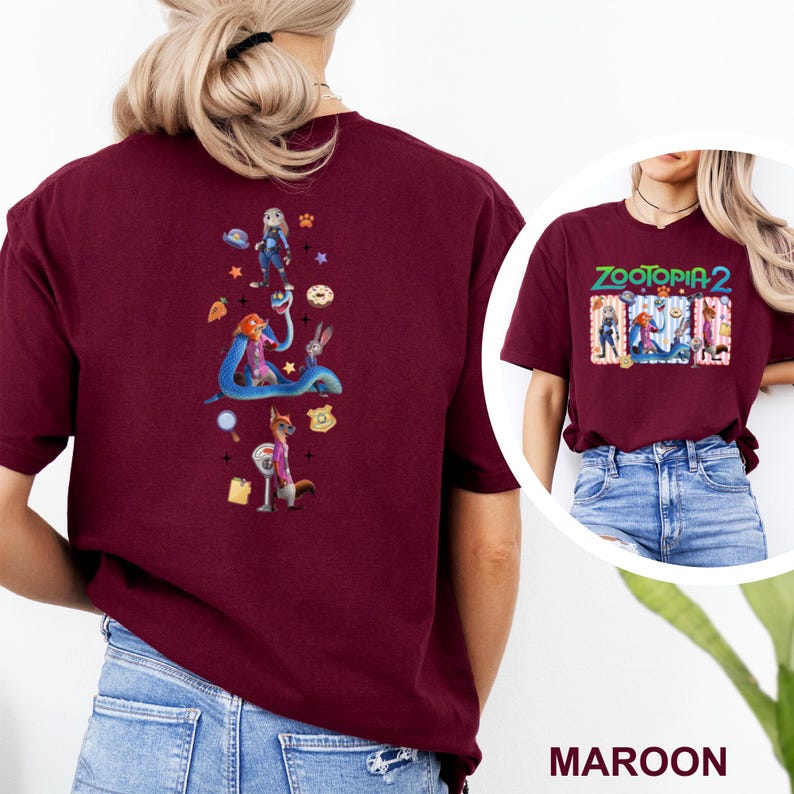 May include: Maroon t-shirt with a vibrant graphic from the film Zootopia 2. The back of the shirt showcases characters and icons. The front of the shirt displays the movie title and characters. The shirt is made of a soft material.