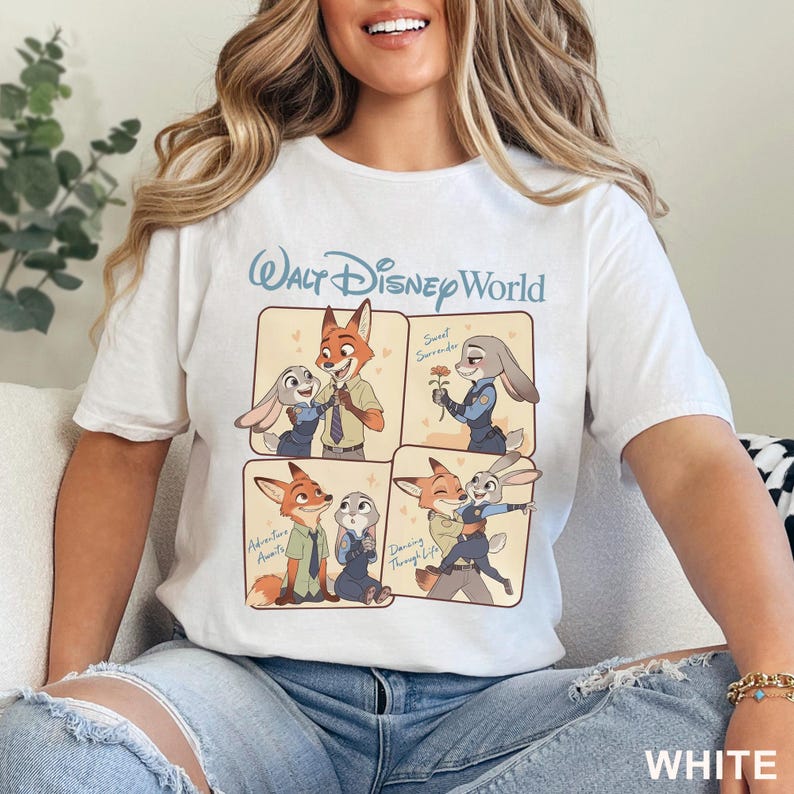 K&ouml;nnte beinhalten: Wei&szlig;es T-Shirt mit einem Walt Disney World-Motiv mit Cartoon-Bildern eines Fuchses und eines Kaninchens in verschiedenen Posen. Auf dem Shirt steht das Wort "WHITE" am unteren Rand.