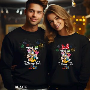 May include: A white ceramic mug with a black handle and the text "But First, Coffee" in a bold, black font. The mug is set against a blurred background, highlighting the clean design.