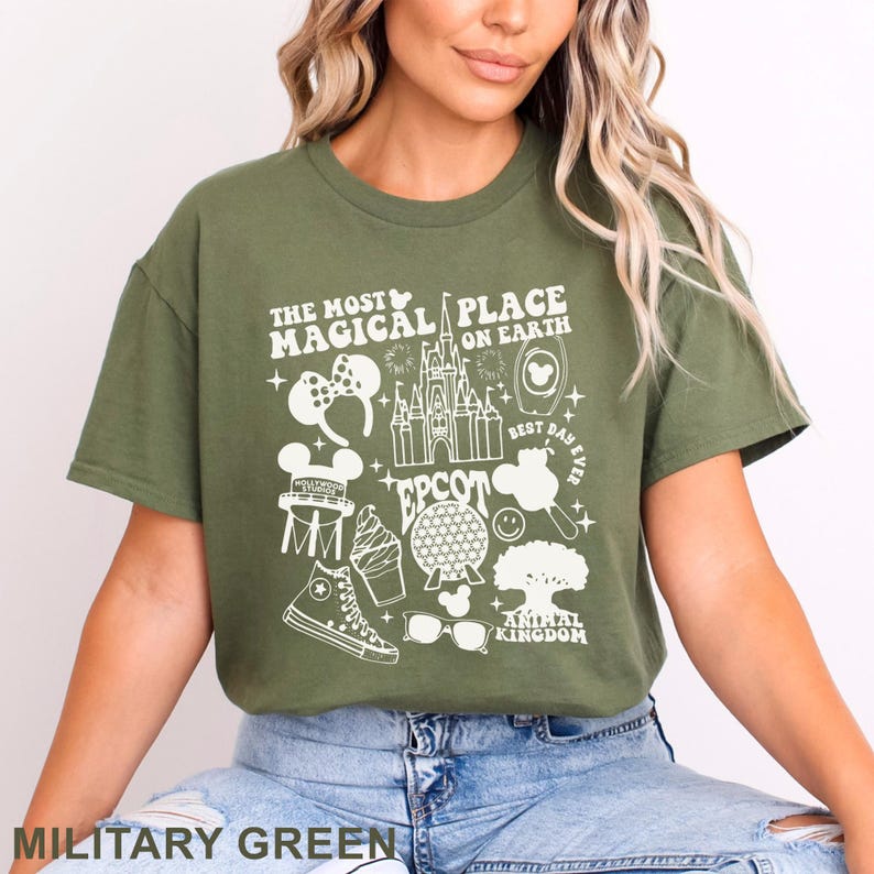 May include: Military green t-shirt with a white graphic featuring Disney park icons and text: "The Most Magical Place on Earth," "Epcot," and "Animal Kingdom." Includes a Mickey Mouse ear headband, castle, and ice cream cone.