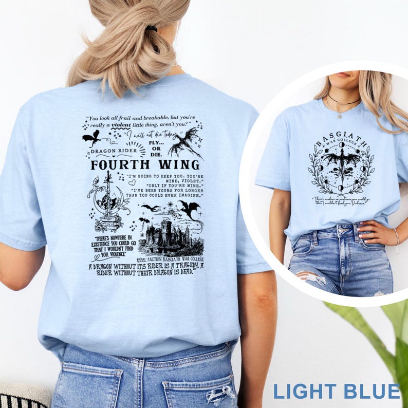 May include: Light blue t-shirts with graphic designs. One shirt features the text "Fourth Wing" with dragon and castle illustrations. The other shirt displays "Basgiath War College" with a dragon and moon phases. Both shirts are made of soft material.
