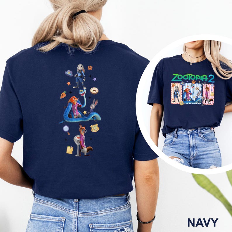 May include: Navy blue t-shirt featuring a colorful graphic from the movie "Zootopia 2" on the front and back. The back design includes characters like Judy Hopps, Nick Wilde, and others. The front design has the movie title and characters.