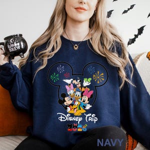 May include: A set of three ceramic mugs with a speckled, matte finish. The mugs are in shades of cream, light gray, and dark gray. Each mug has a simple, minimalist design and a rounded handle.