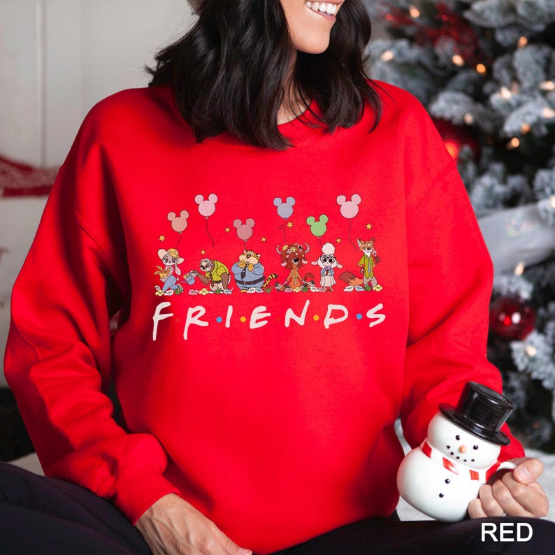 May include: A red sweatshirt featuring the word "FRIENDS" in white, with cartoon characters and Mickey Mouse balloons above. The sweatshirt is a solid red color.