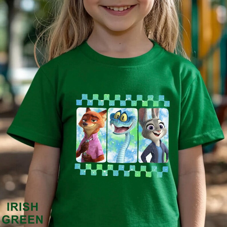 May include: Irish green t-shirt featuring a graphic of three cartoon characters: a fox, a snake, and a rabbit. The graphic is framed by a checkered pattern. The words "IRISH GREEN" are printed at the bottom of the shirt.
