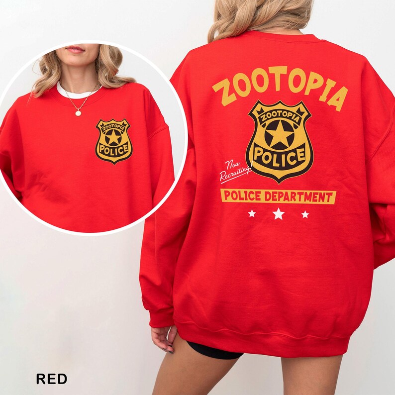 May include: A red sweatshirt featuring the Zootopia Police Department logo on the front and back. The back design includes the text "ZOOTOPIA POLICE DEPARTMENT" in yellow, with the police badge and the words "Now Recruiting".