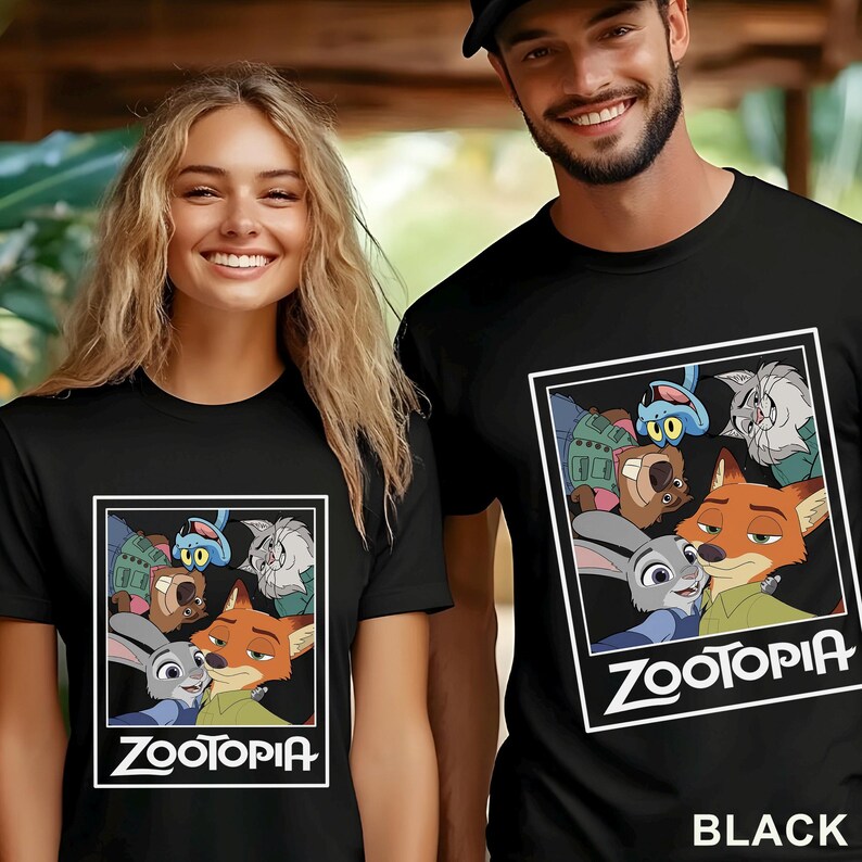 May include: Black t-shirts with a Zootopia graphic. The graphic features characters from the animated film, with the word "Zootopia" in white text below. The shirts are worn by two people.