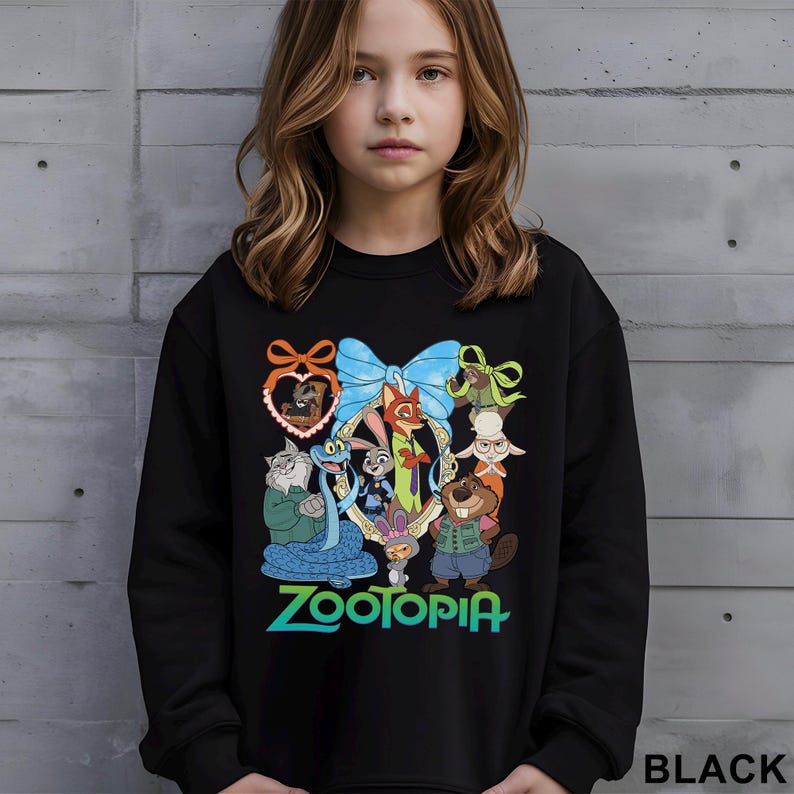 May include: Black sweatshirt with a vibrant graphic of Zootopia characters. The design includes a blue bow, a heart-shaped frame, and the word "Zootopia" in green and blue. The word "BLACK" is printed at the bottom right.