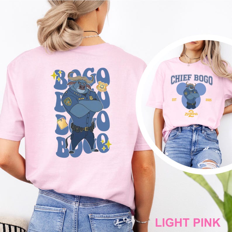 May include: Light pink t-shirts featuring Chief Bogo from Zootopia. One shirt has a large graphic on the back with the text "Bogo" and an illustration of Chief Bogo. The other shirt has "Chief Bogo" printed on the front.