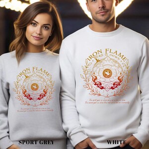 May include: Sport grey and white sweatshirts with a circular graphic design featuring the text "IRON FLAME BURN IT DOWN". The design includes a central emblem with a phoenix and flames, surrounded by a laurel wreath.