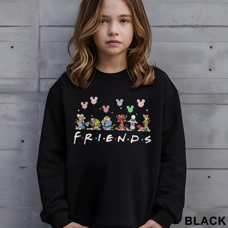 May include: Black sweatshirt featuring a colorful graphic of cartoon characters and the word "FRIENDS" in white. Above the characters are Mickey Mouse-shaped balloons in various colors. The word "BLACK" is printed at the bottom right.