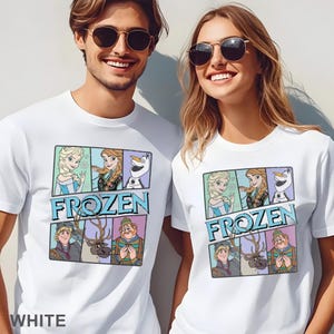 May include: White t-shirts featuring a colorful graphic of characters from the animated film "Frozen." The design includes Elsa, Anna, Olaf, Kristoff, and Sven, with the word "FROZEN" in blue. The word "WHITE" is printed at the bottom of the shirt.
