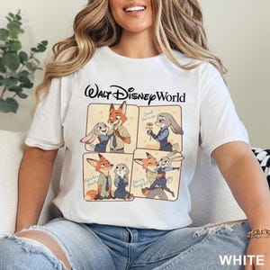 May include: White t-shirt with a Walt Disney World graphic. The graphic features cartoon images of a fox and a rabbit in various poses, with text that reads "Sweet Surrender", "Adventure Awaits", and "Dancing Through Life". The word "WHITE" is printed at the bottom.