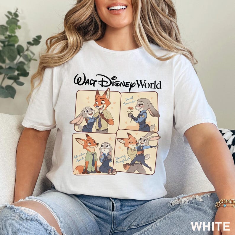 May include: White t-shirt with a Walt Disney World graphic. The graphic features cartoon images of a fox and a rabbit in various poses, with text that reads "Sweet Surrender", "Adventure Awaits", and "Dancing Through Life". The word "WHITE" is printed at the bottom.