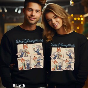 May include: Black sweatshirts featuring a cartoon design of Zootopia characters. The sweatshirts have the text "Walt Disney World" in blue script above the cartoon images. The cartoon images show Nick Wilde and Judy Hopps in various poses. The word "BLACK" is at the bottom.