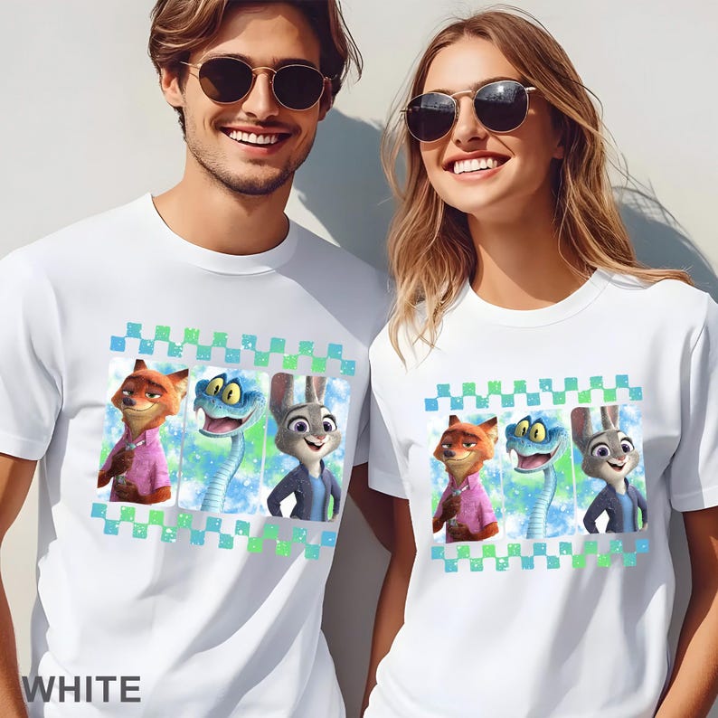 May include: White t-shirts featuring a colorful graphic of cartoon characters. The graphic includes a fox, a snake, and a rabbit. The shirts have a checkered border and the word "WHITE" is printed at the bottom.