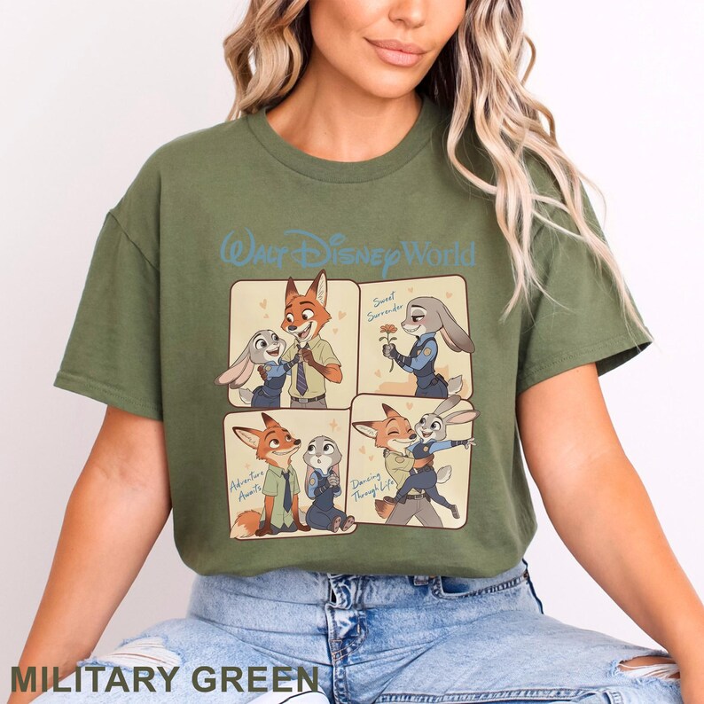 K&ouml;nnte beinhalten: Milit&auml;rgr&uuml;nes T-Shirt mit einem Cartoon-Design mit Charakteren aus Zootopia. Das Design umfasst vier Panels mit Nick Wilde und Judy Hopps. Die Worte "Walt Disney World" stehen oben.