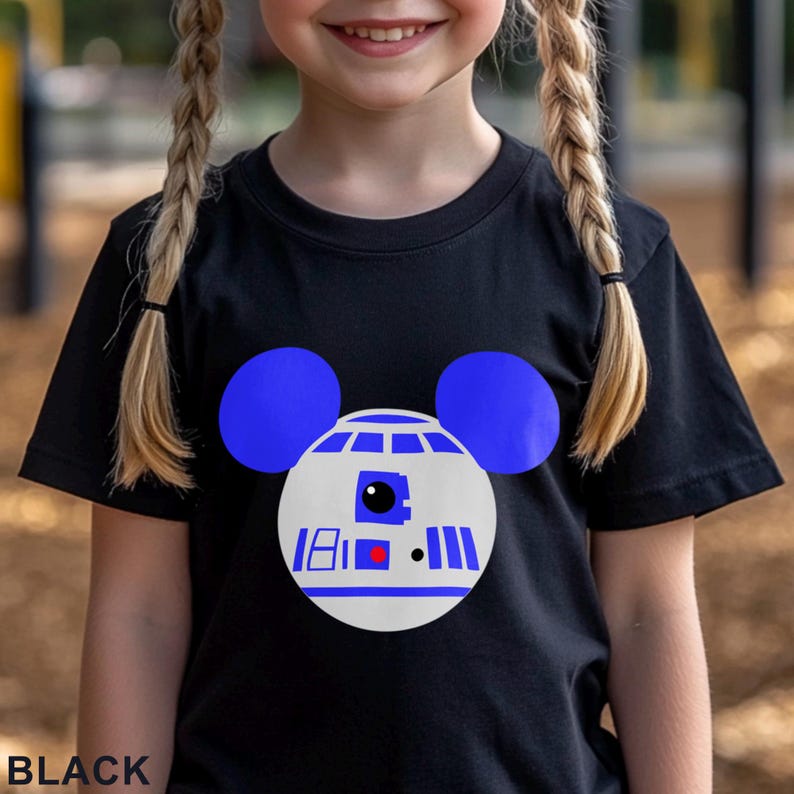 May include: Black t-shirt featuring a graphic of R2-D2 with blue Mickey Mouse ears. The design is white, blue, and red. The word "BLACK" is printed at the bottom of the shirt.