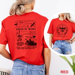 May include: Red t-shirts with black graphic designs. One shirt features text and illustrations related to "Fourth Wing" and "Dragon Rider." The other shirt displays a design with the text "Basgiath War College."