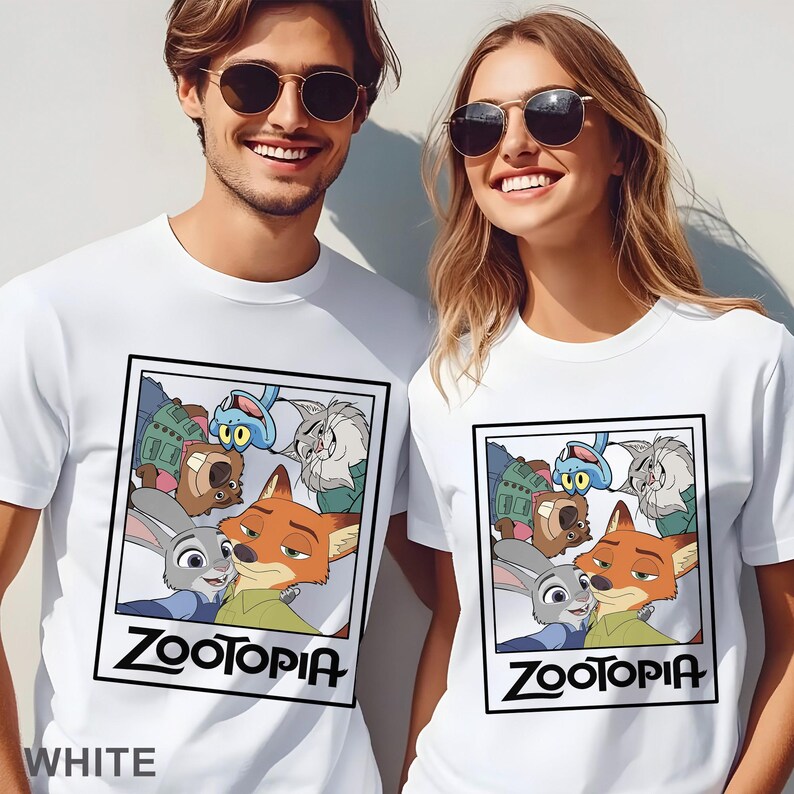 May include: White t-shirts with a Zootopia graphic. The design features characters from the animated film, with the word "Zootopia" in black. The word "WHITE" is printed at the bottom of the shirt.