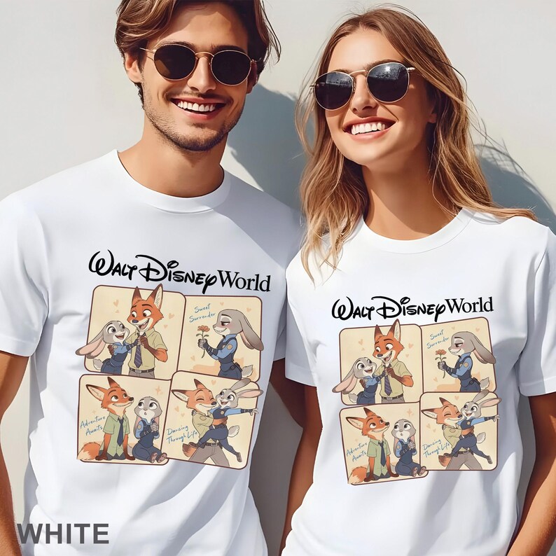 May include: White t-shirts with a Walt Disney World logo and a cartoon graphic of Nick Wilde and Judy Hopps from Zootopia. The graphic includes the phrases "Sweet Surrender", "Adventure Awaits", and "Dancing Through Life".
